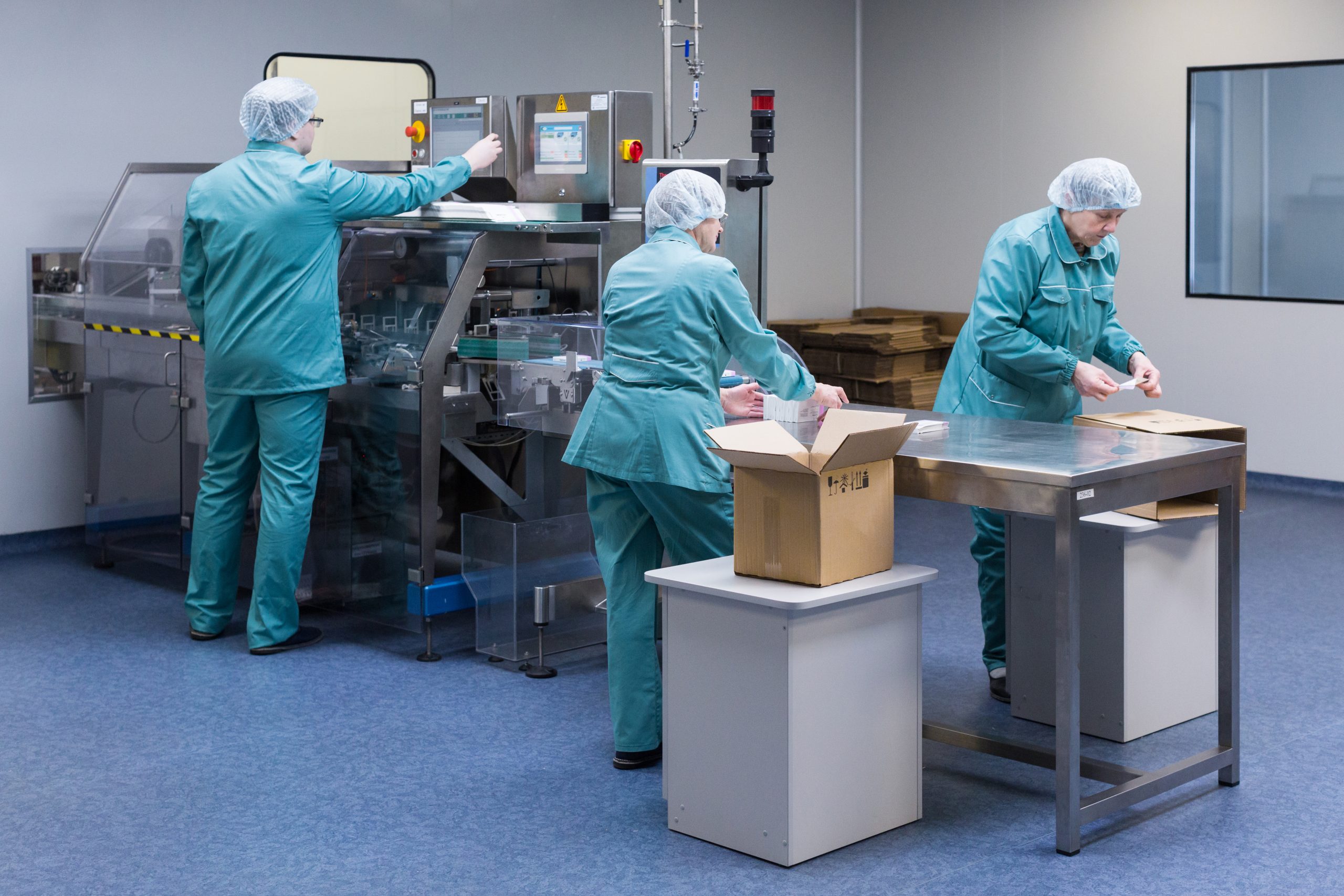 Pharmaceutical factory workers in sterile environment