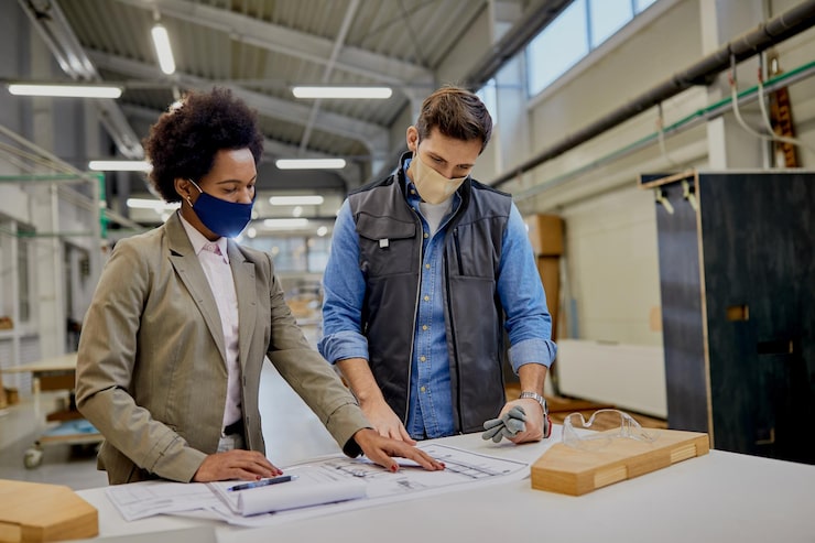 woodworker-black-businesswoman-examining-blueprints-factory-coronavirus-pandemic_637285-11917